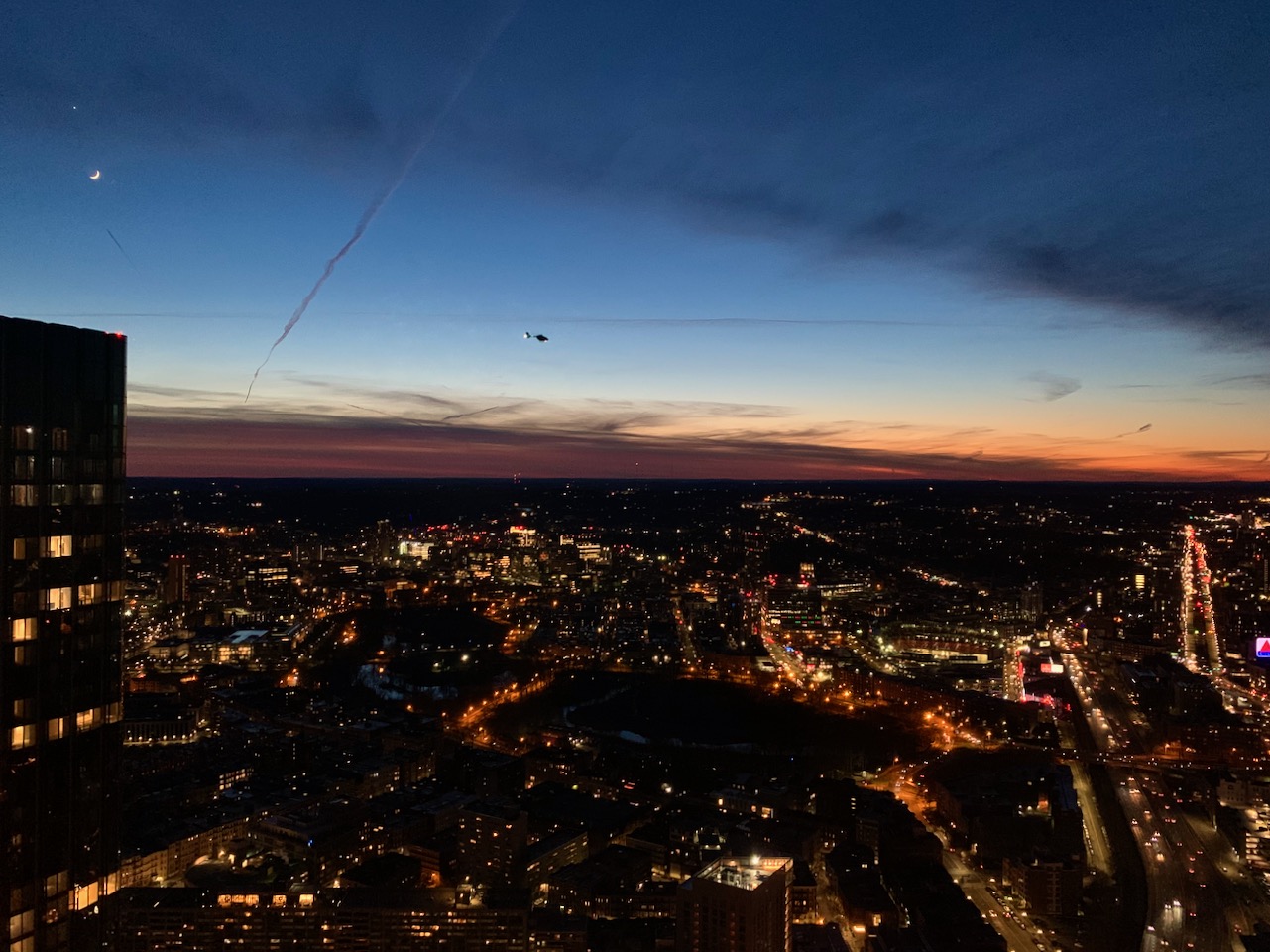 View towards Brookline with the moon and a helicopter